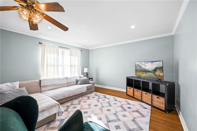 living area with ornamental molding, baseboards, and wood finished floors