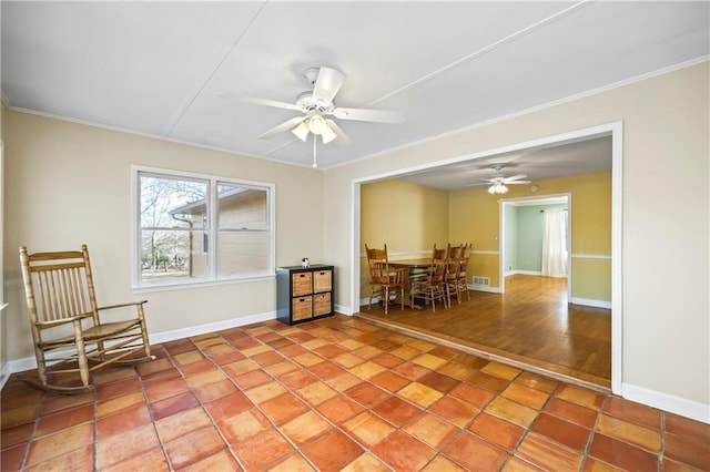 living area featuring a ceiling fan, tile patterned floors, visible vents, and baseboards