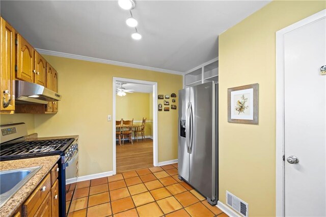 kitchen with light tile patterned floors, under cabinet range hood, visible vents, appliances with stainless steel finishes, and brown cabinets