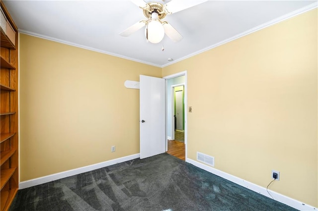 unfurnished room featuring ornamental molding, visible vents, and baseboards