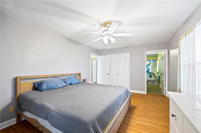 bedroom with ceiling fan, a closet, light wood-type flooring, and baseboards