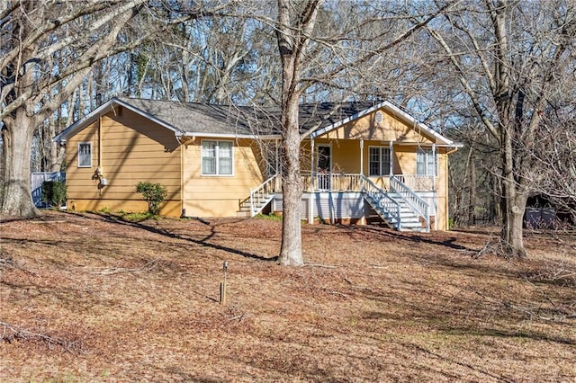 view of front of home with a porch and stairs