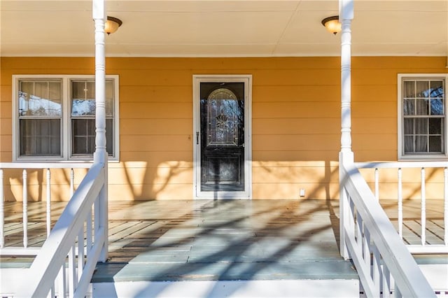 doorway to property featuring covered porch