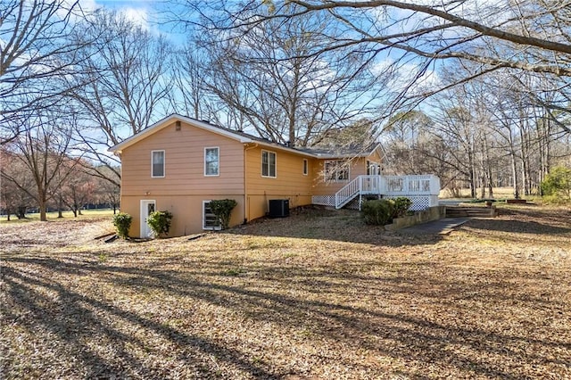 view of home's exterior featuring central AC unit and a deck