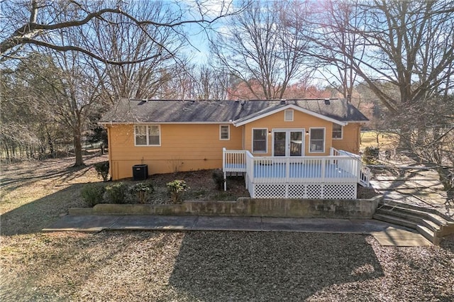 back of house with cooling unit and a deck