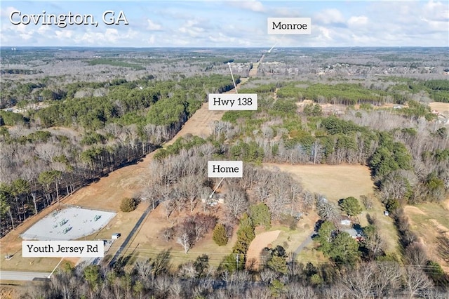 bird's eye view featuring a wooded view