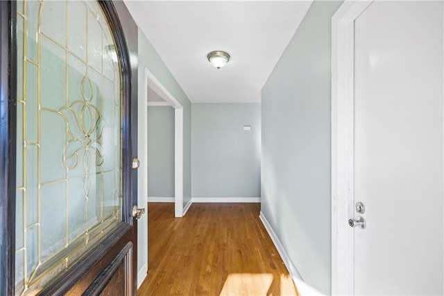 interior space with wood finished floors and baseboards