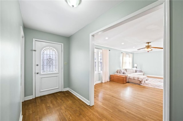 entryway with wood finished floors and baseboards