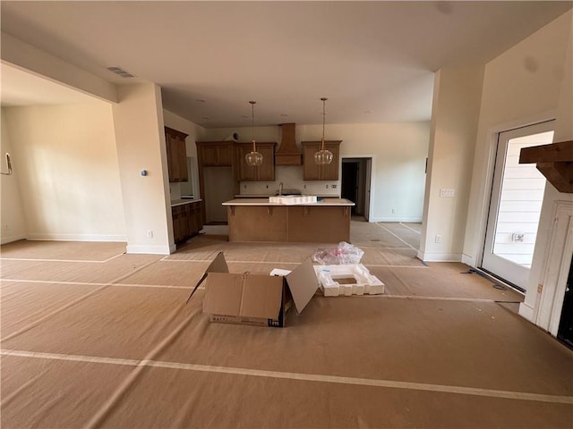 1010 Cable Rd, Waleska, GA 30183 - kitchen featuring custom range hood, a kitchen island, baseboards, and decorative light fixtures