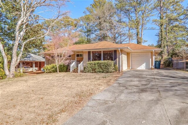 view of front of property with a garage and a front yard