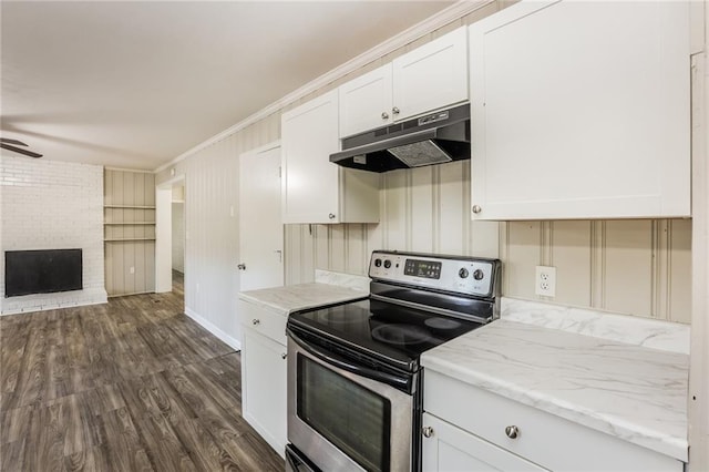 kitchen featuring white cabinetry, stainless steel electric range oven, a brick fireplace, dark hardwood / wood-style flooring, and crown molding