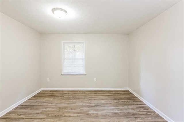 spare room featuring hardwood / wood-style floors