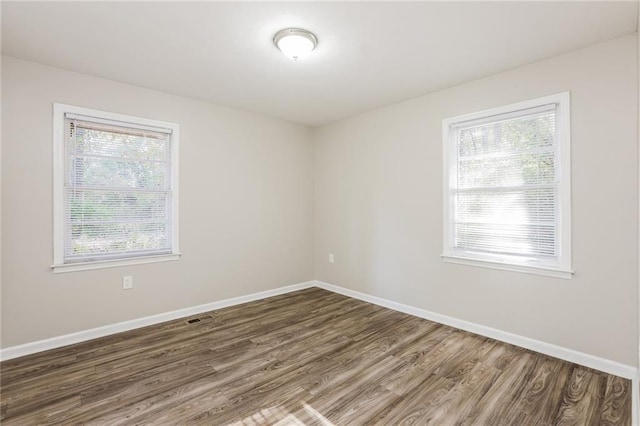 spare room featuring dark hardwood / wood-style floors