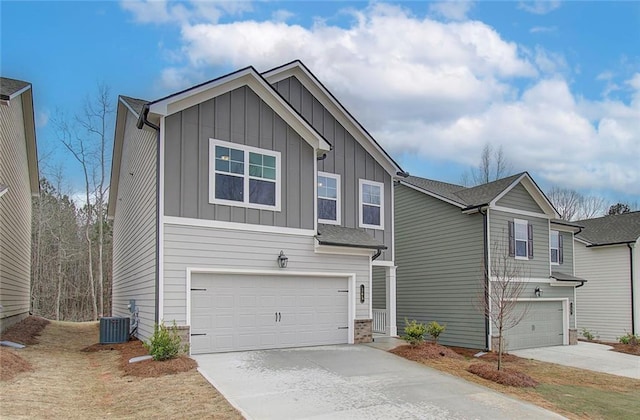 view of front of house featuring a garage and central air condition unit