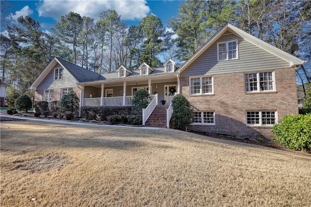 view of front of home with covered porch and a front yard