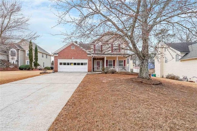 view of front facade featuring a garage, covered porch, and a front lawn