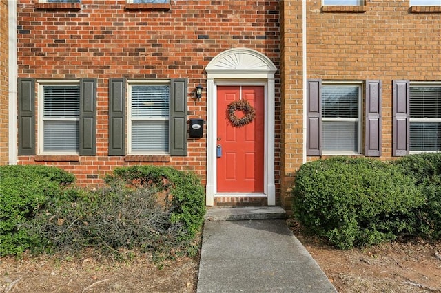 property entrance featuring brick siding