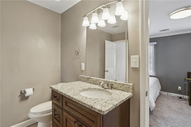 half bath featuring visible vents, toilet, vanity, and baseboards