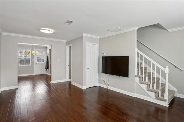 unfurnished living room with stairway, wood finished floors, visible vents, baseboards, and ornamental molding