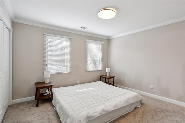 bedroom with carpet flooring, baseboards, visible vents, and a closet