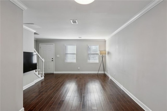 unfurnished living room with stairway, wood finished floors, baseboards, visible vents, and ornamental molding