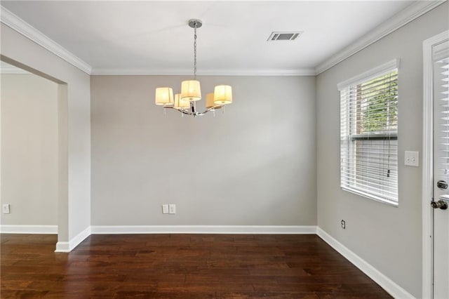 unfurnished dining area featuring an inviting chandelier, crown molding, wood finished floors, and visible vents