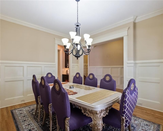 dining area featuring a chandelier, dark hardwood / wood-style floors, and ornamental molding