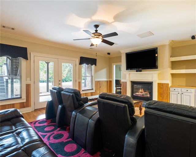 living room featuring ceiling fan, light hardwood / wood-style floors, crown molding, and french doors