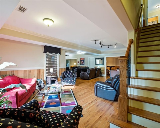 living room featuring light wood-type flooring and ornamental molding