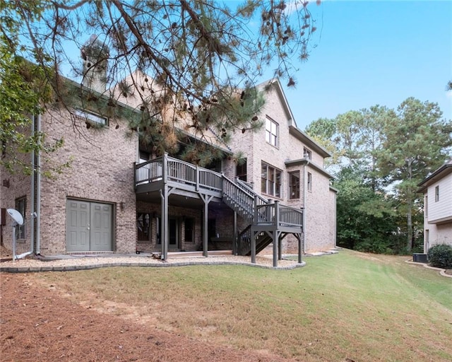 back of property featuring a yard and a deck