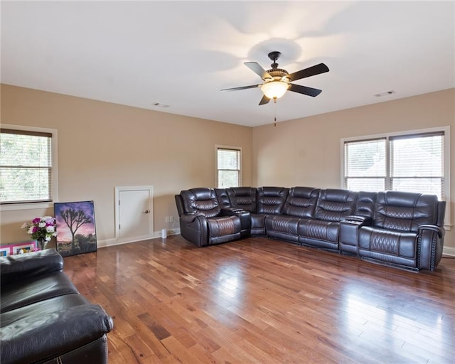 living room with hardwood / wood-style floors and ceiling fan