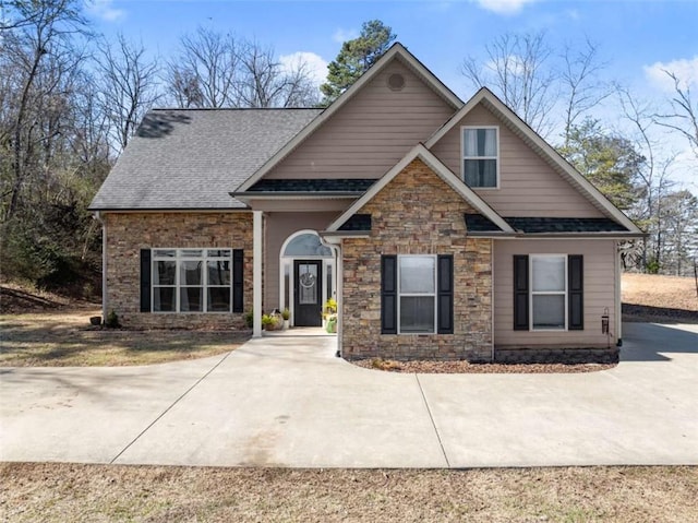 craftsman-style home with roof with shingles