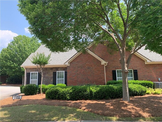 1301 Haven Cir, Douglasville, GA 30135 - view of front of home featuring brick siding, roof with shingles, and stone siding