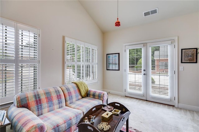 1301 Haven Cir, Douglasville, GA 30135 - living area with plenty of natural light, light carpet, french doors, and high vaulted ceiling