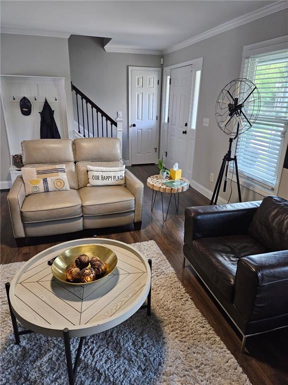 2467 Sky Valley Dr, Dacula, GA 30019 - living area with wood finished floors, stairway, and crown molding