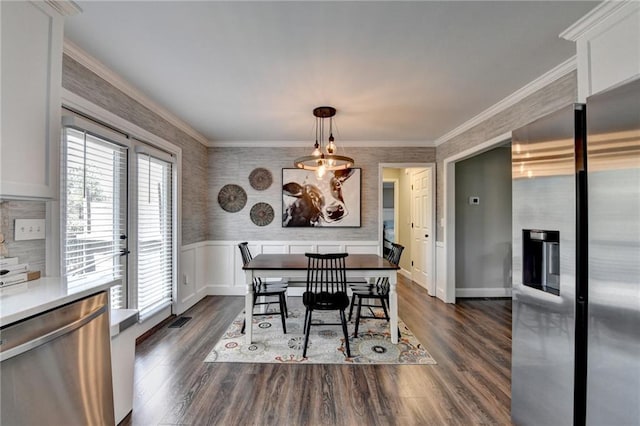 2467 Sky Valley Dr, Dacula, GA 30019 - dining space with wallpapered walls, dark wood-type flooring, wainscoting, crown molding, and french doors