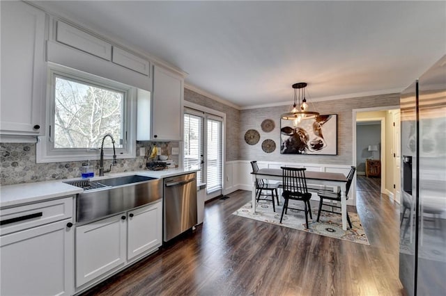 2467 Sky Valley Dr, Dacula, GA 30019 - kitchen with appliances with stainless steel finishes, light countertops, dark wood-style flooring, wallpapered walls, and ornamental molding