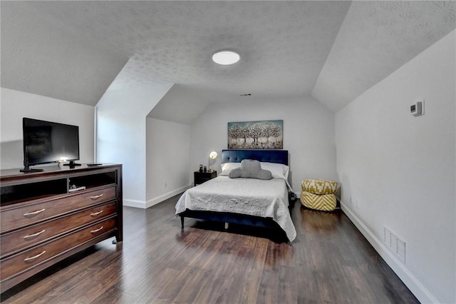 2467 Sky Valley Dr, Dacula, GA 30019 - bedroom featuring lofted ceiling, dark wood-style floors, and a textured ceiling
