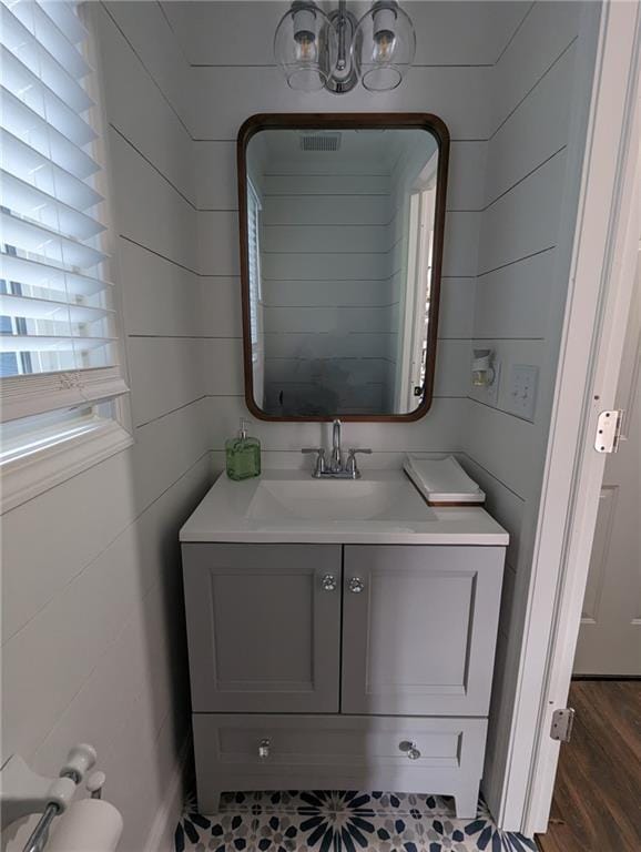 2467 Sky Valley Dr, Dacula, GA 30019 - bathroom featuring vanity, wood finished floors, and a chandelier