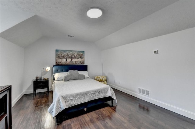 2467 Sky Valley Dr, Dacula, GA 30019 - bedroom with lofted ceiling, wood finished floors, and a textured ceiling