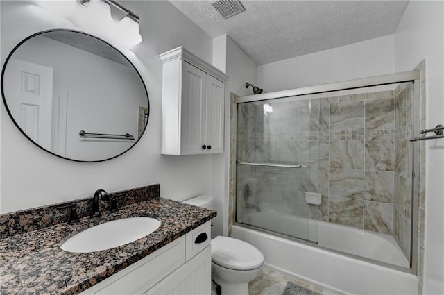 2467 Sky Valley Dr, Dacula, GA 30019 - full bathroom with vanity, combined bath / shower with glass door, and a textured ceiling