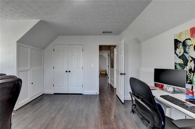 2467 Sky Valley Dr, Dacula, GA 30019 - home office featuring dark wood-type flooring, a textured ceiling, and vaulted ceiling