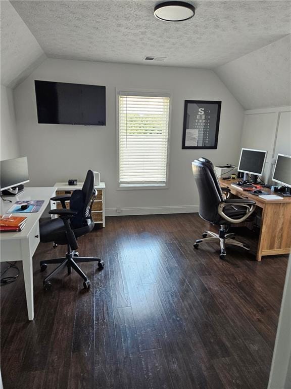 2467 Sky Valley Dr, Dacula, GA 30019 - home office featuring lofted ceiling, wood-type flooring, and a textured ceiling