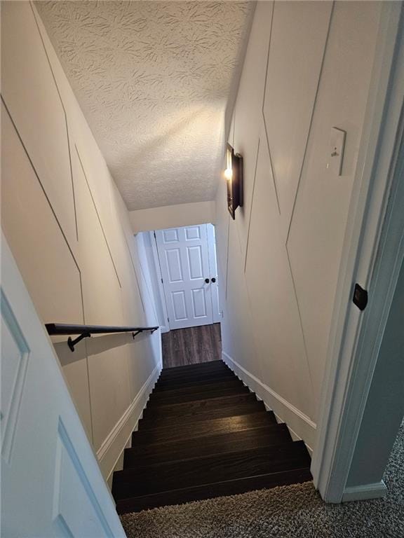 2467 Sky Valley Dr, Dacula, GA 30019 - stairs with wood finished floors and a textured ceiling