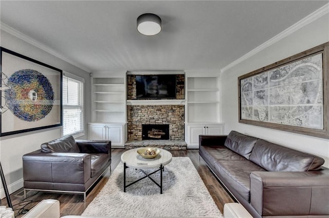 2467 Sky Valley Dr, Dacula, GA 30019 - living room featuring crown molding, wood finished floors, built in shelves, and a stone fireplace