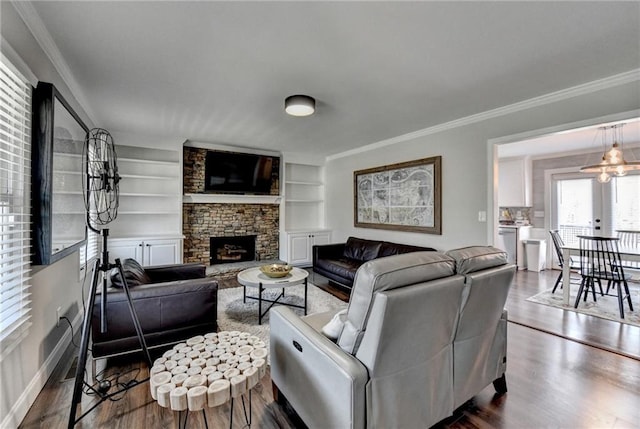 2467 Sky Valley Dr, Dacula, GA 30019 - living room with dark wood-style flooring, a fireplace, crown molding, a chandelier, and built in shelves