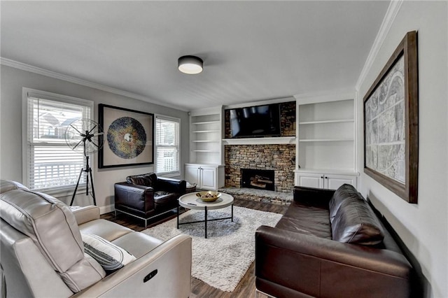 2467 Sky Valley Dr, Dacula, GA 30019 - living area with wood finished floors, crown molding, a stone fireplace, plenty of natural light, and built in features