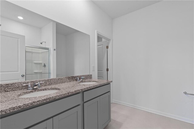 3011 Orwell Dr, Gainesville, GA 30507 - bathroom featuring a sink, baseboards, double vanity, and a stall shower