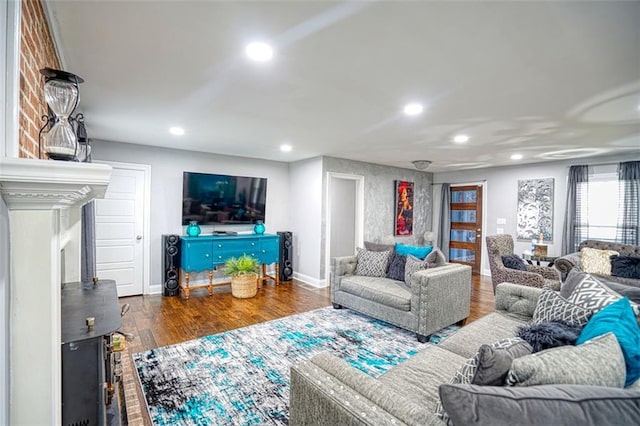 living room featuring baseboards, wood finished floors, and recessed lighting