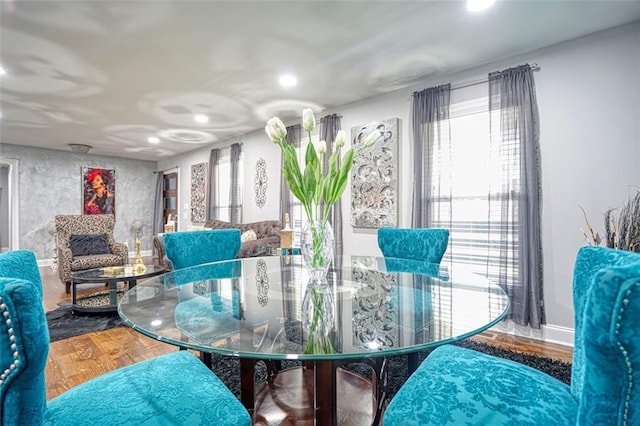 dining area with baseboards, wood finished floors, and recessed lighting